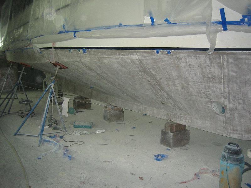 APRIL 22, 2009 001.jpg - Photo shows that they leave very little fairing material on the boat before painting.
